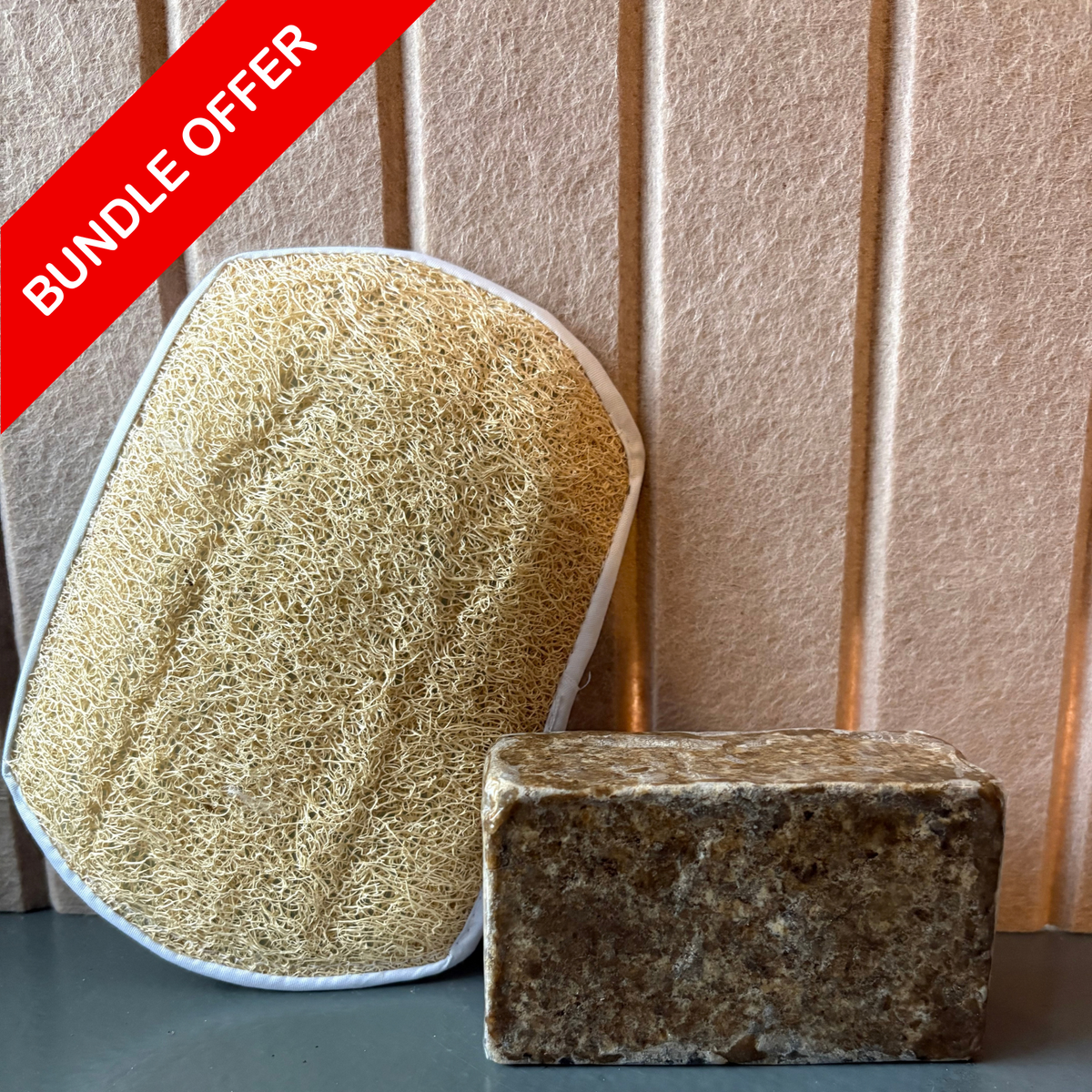 The bundle: 1 black soap + 1 natural loofah sponge
